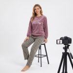 Women's fleece pajama set with dusty mauve full-sleeve sweatshirt and gray-brown checkered pants.