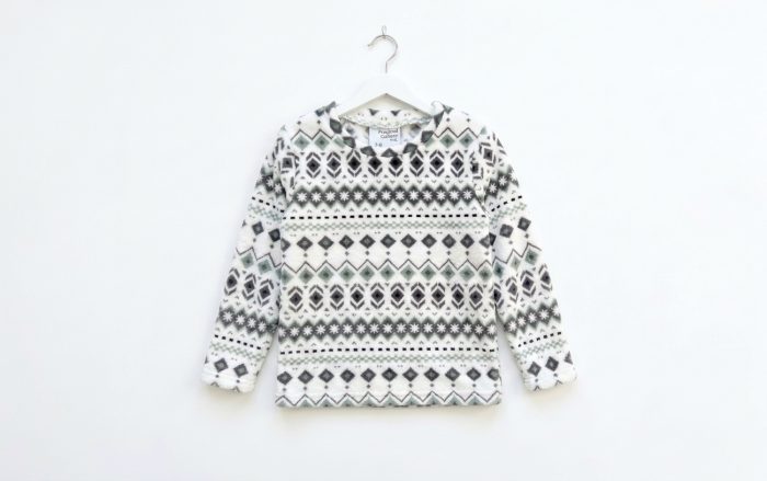 Fleece fabric White sweatshirt hanging on white background.